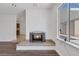 Cozy living room with a built-in fireplace and large window at 7220 Stormson Dr, Las Vegas, NV 89145