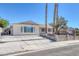 Inviting single-story home featuring a gated front yard, expansive driveway, and desert-friendly landscaping at 7220 Stormson Dr, Las Vegas, NV 89145