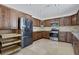 Modern kitchen with wood cabinets and stainless steel appliances at 7220 Stormson Dr, Las Vegas, NV 89145