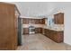 Bright kitchen features granite countertops, stainless steel appliances, tile backsplash, and wooden cabinets at 7220 Stormson Dr, Las Vegas, NV 89145