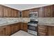 Modern kitchen with wood cabinets and granite countertops at 7220 Stormson Dr, Las Vegas, NV 89145