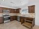 Well-lit kitchen with granite countertops, stainless steel appliances, tile backsplash, and pull out cabinet drawers at 7220 Stormson Dr, Las Vegas, NV 89145