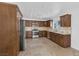 Modern kitchen with stainless steel appliances and wood cabinets at 7220 Stormson Dr, Las Vegas, NV 89145