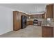 Modern kitchen with stainless steel appliances and wood cabinets at 7220 Stormson Dr, Las Vegas, NV 89145