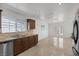 Bright kitchen features stainless steel dishwasher, granite countertops, tile backsplash, and opens to a living area at 7220 Stormson Dr, Las Vegas, NV 89145