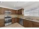 Modern kitchen with wood cabinets and stainless steel appliances at 7220 Stormson Dr, Las Vegas, NV 89145