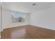 Bright living room featuring hardwood floors and large windows at 7220 Stormson Dr, Las Vegas, NV 89145