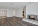 Spacious living room features wood flooring, recessed lights, and a cozy fireplace at 7220 Stormson Dr, Las Vegas, NV 89145