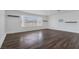 Spacious living room with modern wood-look floors and a bright window at 7220 Stormson Dr, Las Vegas, NV 89145