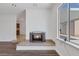 Bright living area features a fireplace, window to the backyard, and natural light at 7220 Stormson Dr, Las Vegas, NV 89145