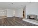Living room with fireplace and wood-look floors at 7220 Stormson Dr, Las Vegas, NV 89145