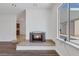 Living room with cozy fireplace, wood flooring, and view to the backyard at 7220 Stormson Dr, Las Vegas, NV 89145