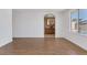 Bright living room features wood floors, white walls, and a view to the bathroom at 7220 Stormson Dr, Las Vegas, NV 89145