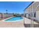 Beautiful backyard pool area with a covered patio and seating at 7220 Stormson Dr, Las Vegas, NV 89145