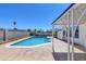 Beautiful backyard pool, partially covered patio, and mature shade tree at 7220 Stormson Dr, Las Vegas, NV 89145