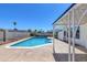 Inviting kidney-shaped pool with a covered patio in the backyard at 7220 Stormson Dr, Las Vegas, NV 89145