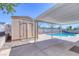 Backyard oasis with a pool, covered patio, and storage shed at 7220 Stormson Dr, Las Vegas, NV 89145