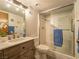 This bathroom features a glass door shower, a marble countertop sink and nice lighting at 725 N Royal Crest Cir # 215, Las Vegas, NV 89169
