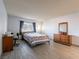 Spacious bedroom features a queen-sized bed, a window and traditional wood furniture at 725 N Royal Crest Cir # 215, Las Vegas, NV 89169