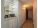 Bright hallway with glass shelving and a view to a separate room with hardwood flooring at 725 N Royal Crest Cir # 215, Las Vegas, NV 89169