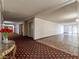 Condo hallway with patterned carpet and tile floors and elevator access at 725 N Royal Crest Cir # 215, Las Vegas, NV 89169