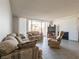Comfortable living room with large sliding doors to balcony and tile floors at 725 N Royal Crest Cir # 215, Las Vegas, NV 89169