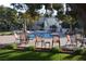 Beautiful outdoor pool area with lounge chairs, dining tables, and manicured grounds at 725 N Royal Crest Cir # 215, Las Vegas, NV 89169