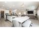 Open concept kitchen with island, white cabinets, and stainless steel appliances at 7611 Phoenix Peak St, Las Vegas, NV 89166