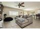 Spacious living room featuring a comfortable sectional sofa and wood-look tile floors at 7611 Phoenix Peak St, Las Vegas, NV 89166