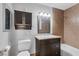 This bathroom features a vanity with storage, tiled wall accents, and toilet at 7950 W Flamingo Rd # 2056, Las Vegas, NV 89147