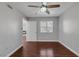 Bedroom with hardwood floors, ceiling fan, window, and en-suite bathroom at 7950 W Flamingo Rd # 2056, Las Vegas, NV 89147