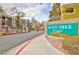 Rain Tree West condos feature a gated entrance, mature landscaping, and colorful buildings, creating an inviting neighborhood at 7950 W Flamingo Rd # 2056, Las Vegas, NV 89147