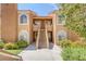 Charming condo building showcasing stucco facade, arched windows, and landscaped surroundings at 7950 W Flamingo Rd # 2056, Las Vegas, NV 89147