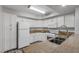 Functional kitchen featuring white appliances, granite countertops, and ample cabinet space at 7950 W Flamingo Rd # 2056, Las Vegas, NV 89147