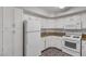 Bright kitchen features white cabinetry, stone countertops, and an all-white appliance suite at 7950 W Flamingo Rd # 2056, Las Vegas, NV 89147