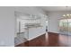 Open kitchen features white cabinets, breakfast bar, and adjacent dining area with sliding doors at 7950 W Flamingo Rd # 2056, Las Vegas, NV 89147