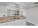 Kitchen with stone countertops and view to living area and fireplace at 7950 W Flamingo Rd # 2056, Las Vegas, NV 89147