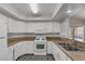 Bright kitchen with stone countertops, white appliances, and eat in breakfast bar at 7950 W Flamingo Rd # 2056, Las Vegas, NV 89147