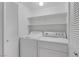 Bright laundry room with in-unit washer and dryer plus shelving for storage at 7950 W Flamingo Rd # 2056, Las Vegas, NV 89147