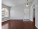 Bright living room with wood floors, vaulted ceilings, and a large arched window provides an open, airy feel at 7950 W Flamingo Rd # 2056, Las Vegas, NV 89147