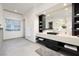 Stylish bathroom with a sleek vanity, black accents, and a view of the outdoor landscape at 1 Boulderback Dr, Henderson, NV 89012