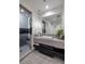 Sleek bathroom with a modern vanity, large mirror, and a glass-enclosed shower for a spa-like experience at 1 Boulderback Dr, Henderson, NV 89012