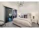 Contemporary bedroom with a large bed, sliding glass doors, and minimalist decor at 1 Boulderback Dr, Henderson, NV 89012