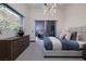 Modern bedroom with a large window, chic lighting, and a comfortable bed with elegant decor at 1 Boulderback Dr, Henderson, NV 89012