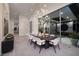 Elegant dining room with modern light fixture and floor to ceiling windows at 1 Boulderback Dr, Henderson, NV 89012