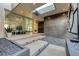 Grand entrance featuring modern design, stone steps, an eye-catching circular window, and stylish landscaping at 1 Boulderback Dr, Henderson, NV 89012