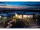 Spectacular exterior home view with lush landscaping and dazzling Las Vegas city views at 1 Boulderback Dr, Henderson, NV 89012