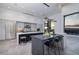 Bright, modern kitchen with island seating, stainless appliances, and mountain views at 1 Boulderback Dr, Henderson, NV 89012
