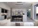 Sleek, modern kitchen and living space featuring stone countertops, stainless steel appliances, and an island with seating at 1 Boulderback Dr, Henderson, NV 89012