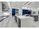 Well lit kitchen showcasing its center island with black and white color scheme and modern appliances at 1 Boulderback Dr, Henderson, NV 89012